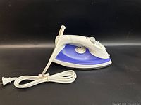 Left side view of Proctor Silex steam iron showing cord and profile