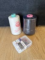 two cones of thread and box of pins