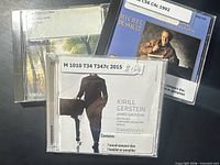 Front view of three CD jewel cases showing titles and library labels
