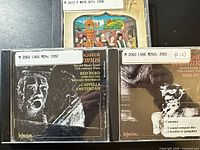Front view of three CD cases showing cover art and library labels
