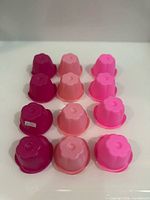 Top view of all 12 cups nested upside-down showing flower shape and color range