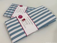 Both packaged napkins showing stripe and gingham patterns