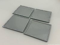 Top view of four mirrored coasters showing bead trim