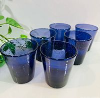 Full set of six cobalt blue tumblers standing upright