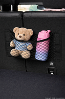 Stock example of mesh net installed on vehicle seat holding items