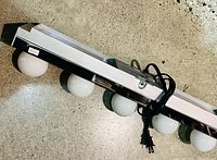 front view of chrome vanity strip showing six bulbs