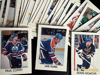 Fronts of sample cards Paul Coffey, Jari Kurri, Doug Gilmour with additional cards fanned out