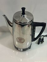 Full view of percolator showing body, lid, spout, handle and cord