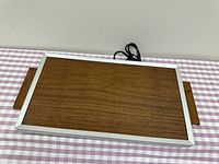 Top view of warming tray showing woodgrain surface and aluminium frame