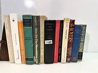 Full row of fourteen hardcover books showing spines