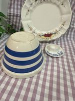 All three ceramics grouped: Cornishware bowl inverted to show stripe pattern, floral platter, blue-floral saucer