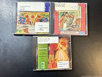 Front covers of the three CDs showing titles and library stickers