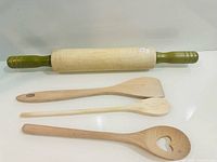 Overall view of rolling pin and three utensils laid out