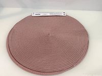 Pair of stacked pink braided round placemats