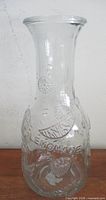 Full view of clear embossed glass carafe