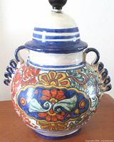 Front view of Talavera pottery lamp showing floral decoration and ribbon handles