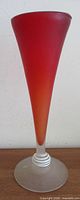 Full view of satin red trumpet vase showing gradient color and pedestal
