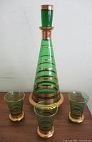 Full set showing decanter with stopper and three matching glasses