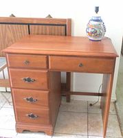 Front view showing five drawers and top surface