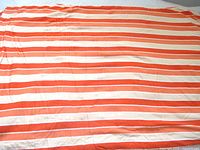 Full view of the striped fabric spread out showing color pattern and overall condition