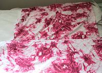 Full length view of fabric showing abstract magenta pattern on white base