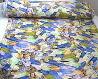 Bolt of colorful peacock feather fabric unrolled