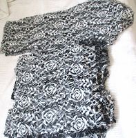 Stacked black and white rose lace fabric pieces