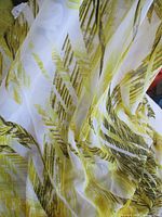 Overall view of semi-transparent yellow & black patterned fabric