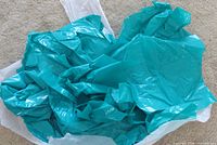Pile of turquoise plastic bags in container