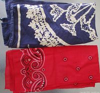 Folded purple and red bandanas showing patterns and tassels