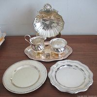Entire lot showing shell dish, creamer, sugar, tray, two plates