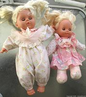 Both dolls side by side displaying size difference and outfits