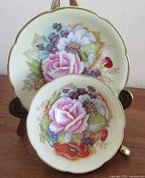 Cup and saucer front view displaying floral design and scalloped shape