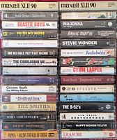 Front view of two stacks showing cassette spines, artists and album titles