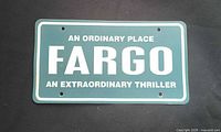 Front of green plastic license plate showing Fargo promotional text