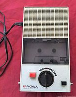 Front view showing speaker grille, controls, brand name