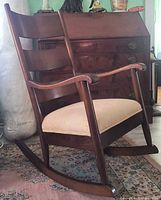 Full view of wooden ladderback rocking chair, right side profile