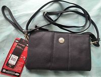 Front view of Stone Mountain black pebbled leather crossbody bag with tags attached