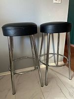 Pair of bar stools showing full form, seats, legs