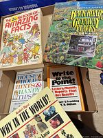Group shot of five books in shoebox showing titles