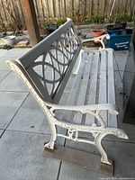 Full side view of bench showing frame, back panel and seat slats