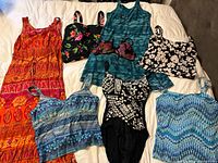 All eight swimwear pieces laid out on bed