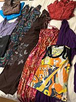 Grouping of multiple garments on bed showing colours and patterns