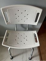Full view of shower chair showing seat, backrest, legs