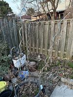 Three blue spiral metal stakes standing in garden area