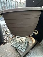 Cast iron holder with brown resin planter