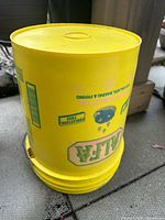 Yellow ALFA-branded plastic pail on concrete
