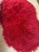 Top view showing bright red shag surface and irregular shape