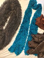 Group view of all four textured scarves on white surface