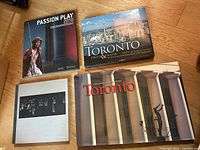 Four hardcover books displayed face up